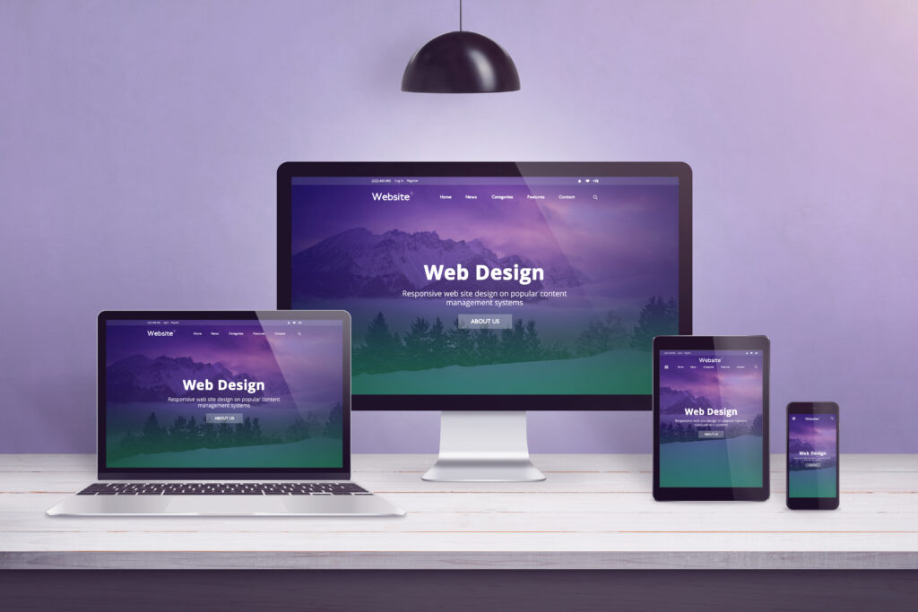 Flat design web site concept on multiple devices. Work desk with laptop, computer display, smart phone and tablet. Purple wall in bacground.