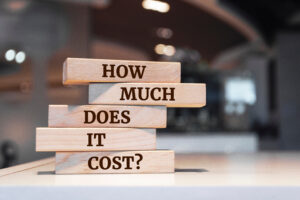 Wooden blocks with words 'How Much Does it Cost?'.
